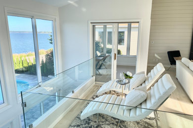Inspiration for a large coastal living room remodel in New York with a stone fireplace