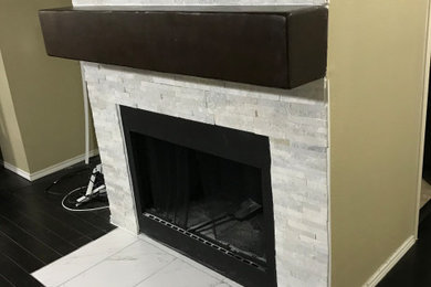 Inspiration for a mid-sized industrial open concept brown floor living room remodel with a standard fireplace, a plaster fireplace and a wall-mounted tv
