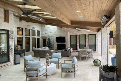 Inspiration for a mid-sized timeless stone patio remodel in Dallas with a fireplace and a roof extension