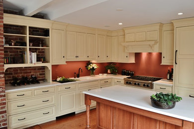 Eat-in kitchen - mid-sized traditional l-shaped medium tone wood floor eat-in kitchen idea in DC Metro with beaded inset cabinets, beige cabinets, marble countertops, stainless steel appliances, an island, an undermount sink and orange backsplash