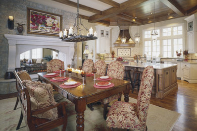 Kitchen/dining room combo - large traditional dark wood floor kitchen/dining room combo idea in Nashville with white walls, a stone fireplace and a two-sided fireplace