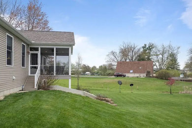 Inspiration for a small modern backyard second story mixed material railing deck remodel in Philadelphia with a roof extension