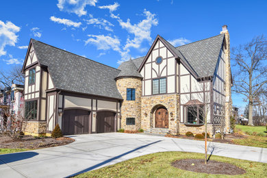 Large traditional beige two-story mixed siding house exterior idea in Cincinnati with a shingle roof
