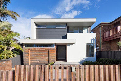 Large contemporary two-storey white house exterior in Sydney with a flat roof.