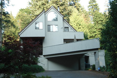 Large elegant white two-story wood exterior home photo in Seattle