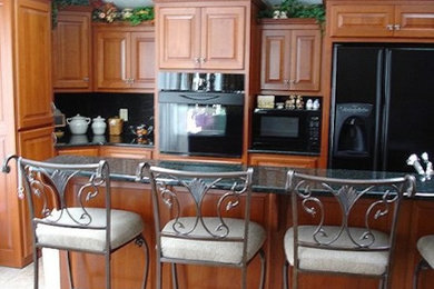Example of a large kitchen design in Cleveland with medium tone wood cabinets and an island