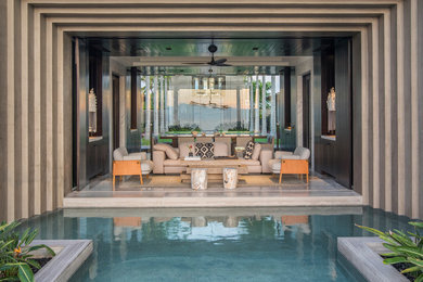 Living room - large tropical open concept gray floor living room idea in Other with black walls