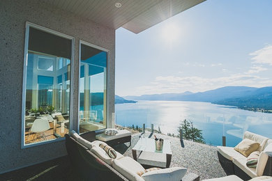 Deck - mid-sized modern side yard deck idea in Vancouver with a roof extension