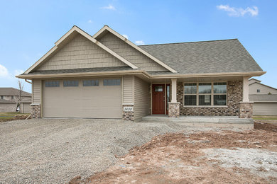 Mid-sized traditional beige one-story mixed siding exterior home idea in Other with a shingle roof