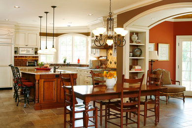 Kitchen - country kitchen idea in Philadelphia with a farmhouse sink, recessed-panel cabinets, white cabinets, granite countertops and paneled appliances