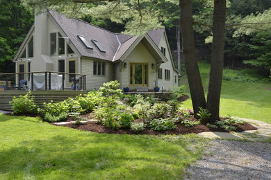 Example of a small country home design design in New York