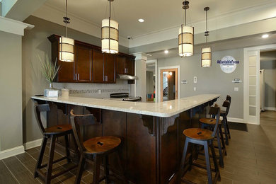 Inspiration for a large contemporary l-shaped wet bar remodel in St Louis with flat-panel cabinets and dark wood cabinets