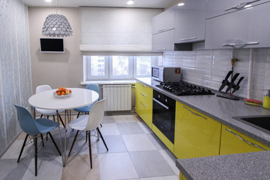 Mid-sized trendy l-shaped enclosed kitchen photo in Moscow with yellow cabinets, no island, a drop-in sink, flat-panel cabinets, white backsplash, subway tile backsplash and black appliances