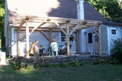 Country backyard brick patio photo in Bridgeport with a pergola