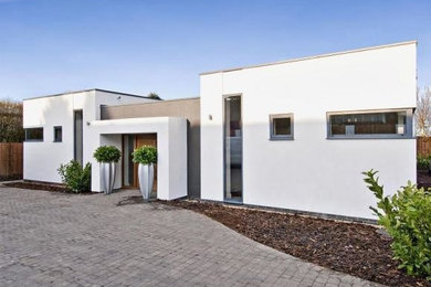 White modern bungalow render house exterior with a flat roof.