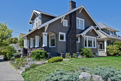 Example of a mid-sized arts and crafts gray two-story mixed siding exterior home design in Seattle with a shingle roof