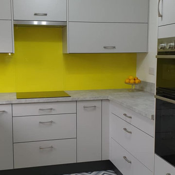 Grey slab kitchen with Retro style flooring