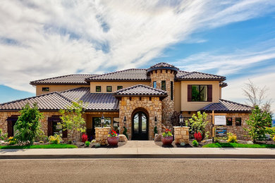 Inspiration for a huge mediterranean beige three-story stone exterior home remodel in Boise