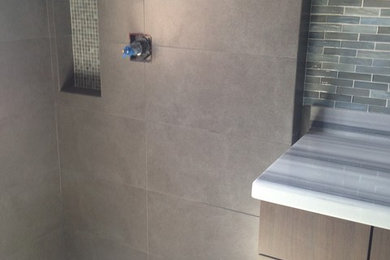 Example of a large trendy gray tile and porcelain tile porcelain tile freestanding bathtub design in Los Angeles with an undermount sink, marble countertops, a one-piece toilet and blue walls