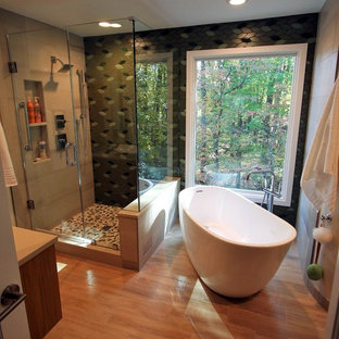 Mid-sized asian master green tile and porcelain tile porcelain floor and brown floor bathroom photo in DC Metro with flat-panel cabinets, light wood cabinets, a one-piece toilet, green walls, a vessel sink, quartz countertops and a hinged shower door