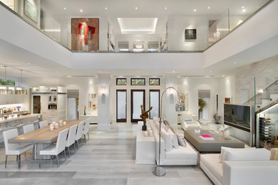 Example of a trendy open concept medium tone wood floor living room design in Miami with white walls