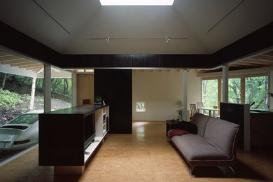 Modern enclosed living room with black walls and brown floor.