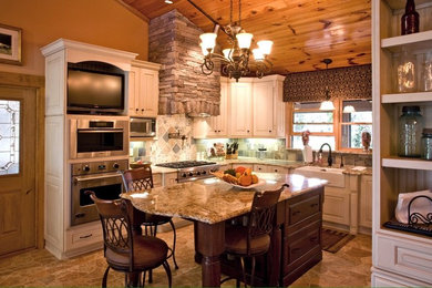 Design ideas for a mid-sized country u-shaped eat-in kitchen in Orlando with a farmhouse sink, raised-panel cabinets, white cabinets, multi-coloured splashback, stone tile splashback, stainless steel appliances, with island, granite benchtops and brown floor.