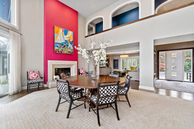 Inspiration for a huge coastal carpeted and gray floor dining room remodel in Baltimore with pink walls, a two-sided fireplace and a plaster fireplace