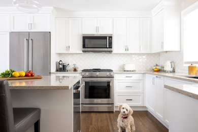 Example of a transitional kitchen design in Calgary