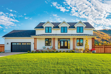 Large cottage white two-story wood exterior home idea with a shingle roof