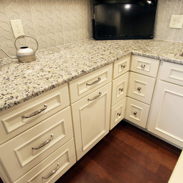 Medallion Painted White Chocolate Kitchen Cabinets with Petal Mosaic Backsplash