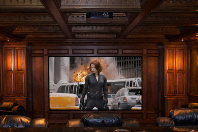 Example of a large classic enclosed carpeted home theater design in Chicago with brown walls and a projector screen