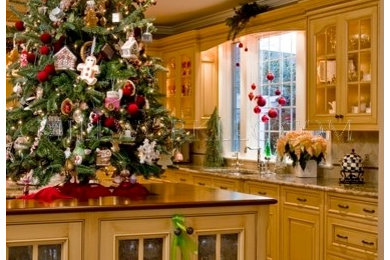 Inspiration for a large timeless u-shaped medium tone wood floor eat-in kitchen remodel in Philadelphia with granite countertops, beige backsplash, a double-bowl sink, raised-panel cabinets, yellow cabinets, terra-cotta backsplash, stainless steel appliances and an island