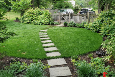 Photo of a mid-sized farmhouse partial sun side yard stone and wood fence garden path in Philadelphia for summer.