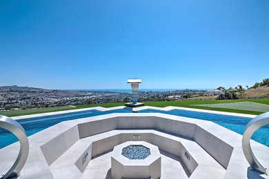 Pool fountain - large contemporary backyard concrete paver and custom-shaped infinity pool fountain idea in Orange County