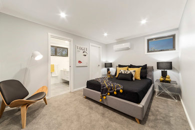 Contemporary master bedroom in Melbourne with grey walls, carpet and beige floor.
