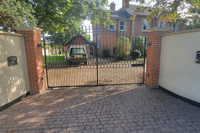 Photo of a large front driveway garden in Berkshire with a gate and a metal fence.