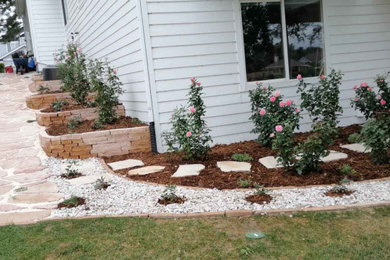 This is an example of a mid-sized contemporary backyard stone landscaping in Denver.
