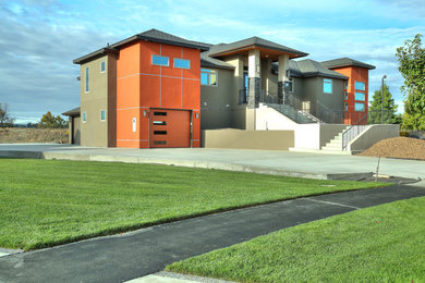 Huge contemporary multicolored two-story stucco exterior home idea in Seattle