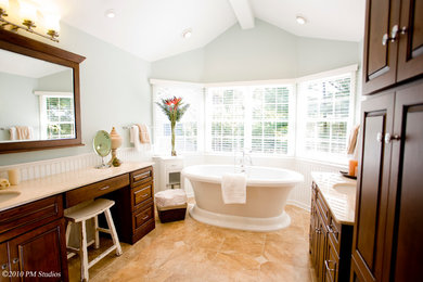 Bathroom - large traditional master beige tile and stone tile travertine floor bathroom idea in New York with raised-panel cabinets, dark wood cabinets, a one-piece toilet, green walls, an undermount sink and granite countertops