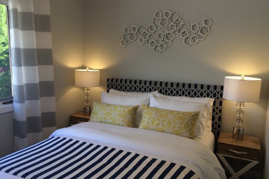Inspiration for a small transitional guest dark wood floor and brown floor bedroom remodel in Other with gray walls