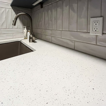 Laundry Room with Blue Painted Cabinetry and Sparkling White Quartz Countertops