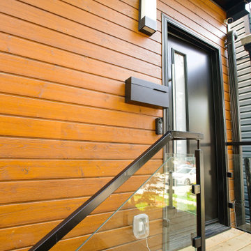 Horizontal Wood Siding and Black-Framed Glass Railing Detail | East York