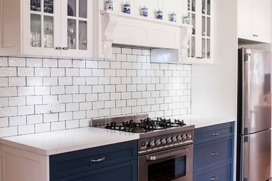Mid-sized traditional l-shaped eat-in kitchen in Sydney with shaker cabinets, white cabinets, granite benchtops, white splashback, subway tile splashback, stainless steel appliances, no island, a farmhouse sink and medium hardwood floors.