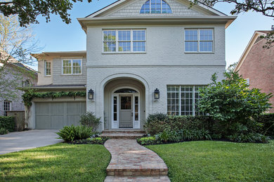 Large traditional gray two-story brick exterior home idea in Houston with a shingle roof