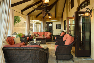 Patio - mid-sized mediterranean backyard stone patio idea in San Francisco with a roof extension
