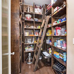 Mid-sized rustic kitchen pantry pictures - Example of a mid-sized mountain style u-shaped dark wood floor and brown floor kitchen pantry design in Calgary