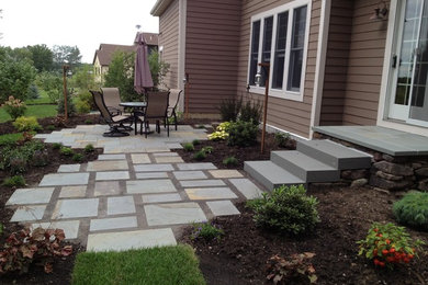 Design ideas for a mid-sized contemporary backyard garden in Minneapolis with natural stone pavers.