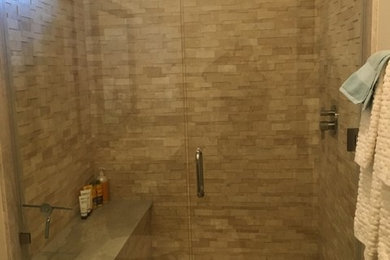Example of a mid-sized mountain style 3/4 beige tile and stone tile alcove shower design in Salt Lake City with dark wood cabinets, a two-piece toilet, beige walls and quartz countertops