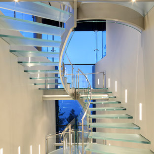 Photo of a contemporary glass staircase in Other with open risers.